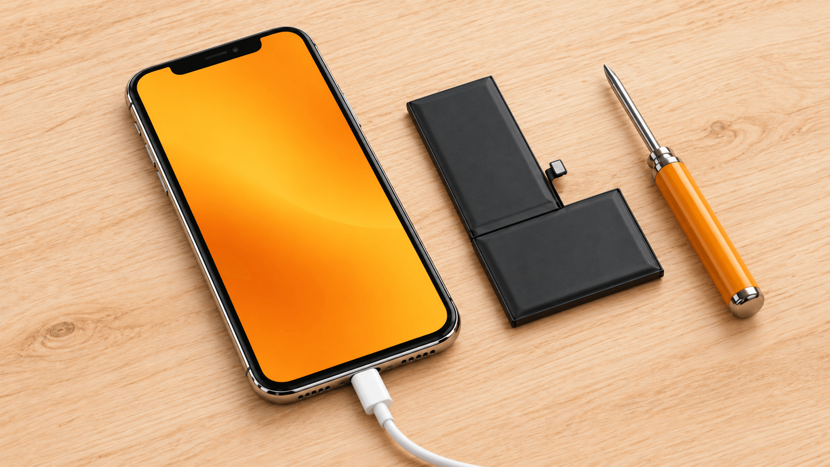 充電ケーブルにつながれたiPhone Xと、小さなドライバーや交換用部品